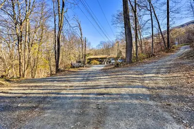 a dirt road in the middle of a forest at Charming Beacon Apt with Fire Pit Near Hiking! in Beacon