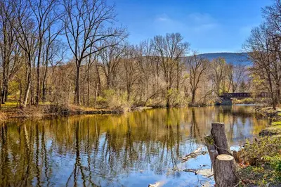 a view of a river with a bridge in the background at Charming Beacon Apt with Fire Pit Near Hiking! in Beacon