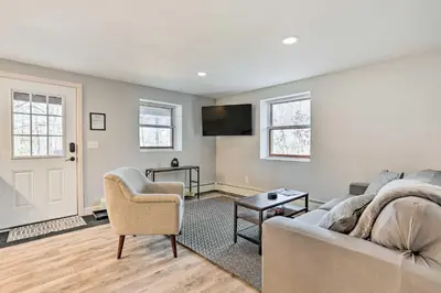 a living room with a couch and chairs and a tv at Charming Beacon Apt with Fire Pit Near Hiking! in Beacon