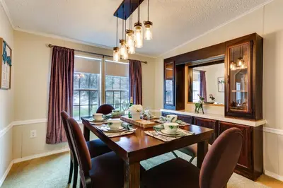 a dining room with a wooden table and chairs at Kayaks, Electric Bicycles Greentown Hideaway! in Greentown