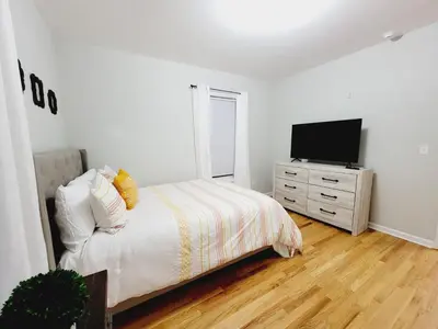 a bedroom with a bed and a television on a dresser at Room for rent in apartment Hartford, CT in Hartford