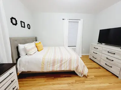a bedroom with a bed and a flat screen tv at Room for rent in apartment Hartford, CT in Hartford