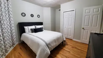 a bedroom with a bed with a black and white comforter at Room for rent in apartment Hartford, CT in Hartford