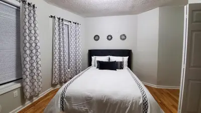 a bedroom with a bed with a black headboard at Room for rent in apartment Hartford, CT in Hartford