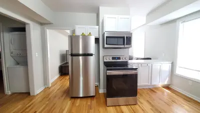 a kitchen with a stainless steel refrigerator and microwave at Room for rent in apartment Hartford, CT in Hartford