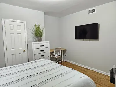 a bedroom with a bed and a tv on a wall at Room for rent in apartment Hartford, CT in Hartford