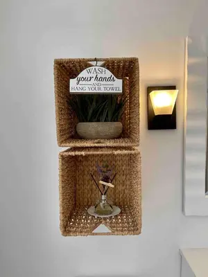 a wicker shelf with a sign on a wall at Modern Chic CoCo Chanel Inspired * Biz Friendly * Close To All in Hicksville