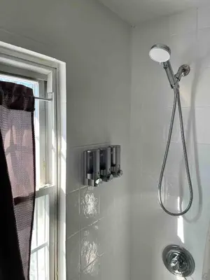 a shower in a bathroom next to a window at Modern Chic CoCo Chanel Inspired * Biz Friendly * Close To All in Hicksville