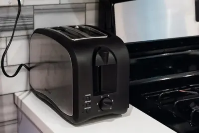 a black toaster sitting on a counter next to an oven at Gorgeous 1BR Wooster Sq. apt. - wshr/dryr, parking in New Haven