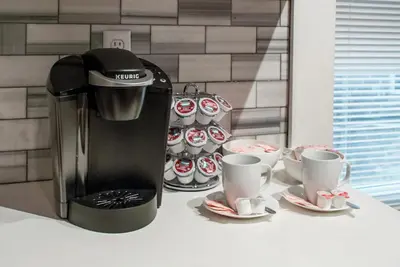 a coffee maker and two cups on a counter at Gorgeous 1BR Wooster Sq. apt. - wshr/dryr, parking in New Haven