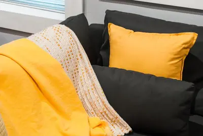 a yellow and black couch with two pillows at Gorgeous 1BR Wooster Sq. apt. - wshr/dryr, parking in New Haven