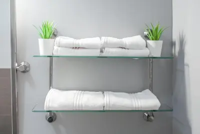 a stack of towels on shelves in a bathroom at Gorgeous 1BR Wooster Sq. apt. - wshr/dryr, parking in New Haven