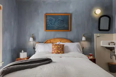 a bedroom with a large bed and a sink at Howland House in Mount Tremper