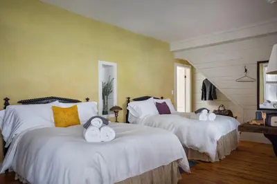 a bedroom with two beds with stuffed animals on them at Howland House in Mount Tremper