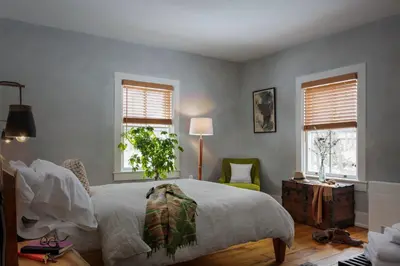 a bedroom with a large bed and two windows at Howland House in Mount Tremper