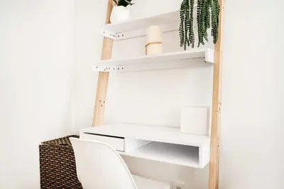 a room with white shelves and a white chair at 69-2C Brand New PRIME Lower East Side 1br Apt in New York