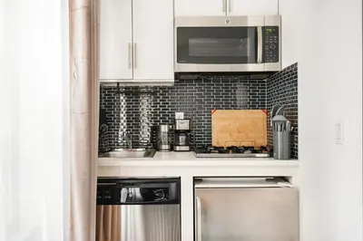 a kitchen with stainless steel appliances and a microwave at 69-3A Prime LES Modern Brand New 1BR in New York