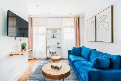 a living room with a blue couch and a table at 69-3B Prime Lower East Side BRAND NEW 1br Apt in New York