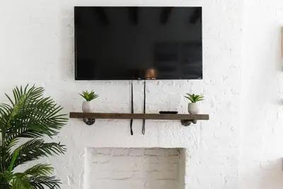 a flat screen tv hanging on a wall at 24-14 Renovated studio Prime gramercy W D in New York