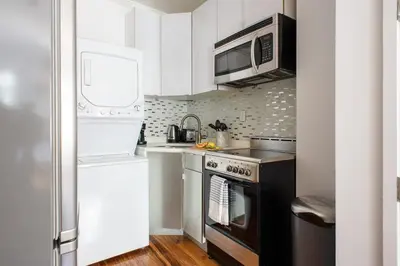 a small kitchen with a stove and a microwave at 24-16 Studio Gramercy W D gramercy in New York