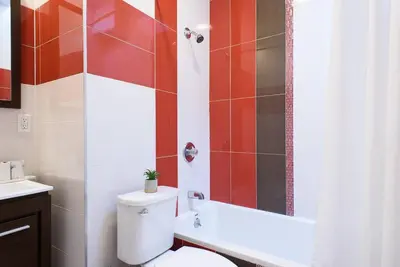 a bathroom with a white toilet and a shower at 24-17 Renovated Studio Prime Location WD in New York