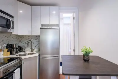 a kitchen with a stainless steel refrigerator and a counter at 24-17 Renovated Studio Prime Location WD in New York