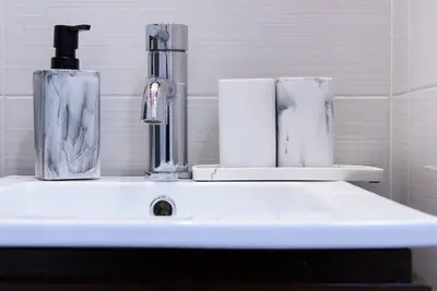 a bathroom sink with two vases on top of it at 24-17 Renovated Studio Prime Location WD in New York