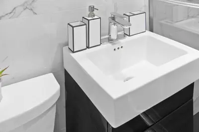 a bathroom with a white sink and a toilet at 69-4B Modern Lower East Side 1BR PRIME LOCATION in New York