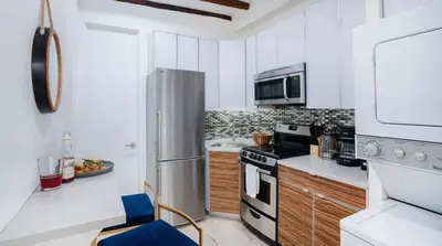 a kitchen with a refrigerator and a stove top oven at 24-3 Prime Gramercy New Studio W D Terrace in New York