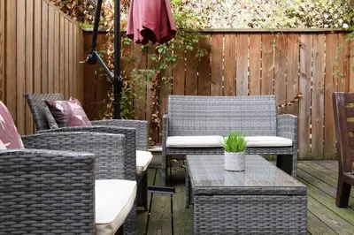 a patio with chairs and tables and an umbrella at 24-3 Prime Gramercy New Studio W D Terrace in New York