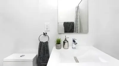 a white bathroom with a sink and a mirror at 24-3 Prime Gramercy New Studio W D Terrace in New York