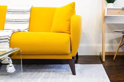 a yellow chair sitting in a living room at 69-4C PRIME Lower East Side 1br Apt Brand New in New York