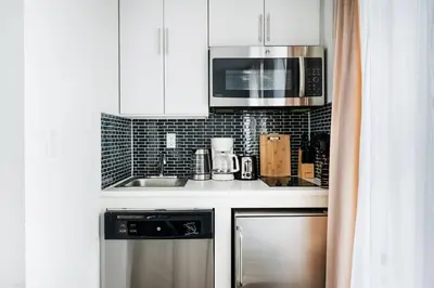 a kitchen with a sink and a microwave at 69-5B I Stylish Lower East Side 1BR Apt BRAND NEW in New York