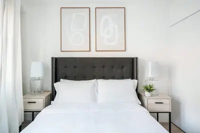 a bedroom with a white bed with two night stands at 809-2A Gorgeous 1BR New W D Modern Best Location in New York