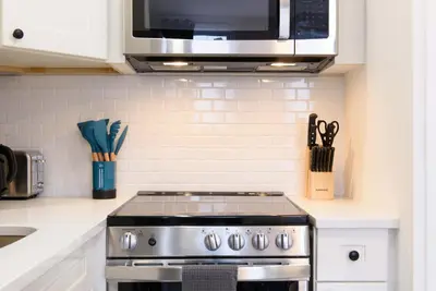 a kitchen with a stove and a microwave at 240-11 NEW STUDIO Prime Upper East W&D in New York