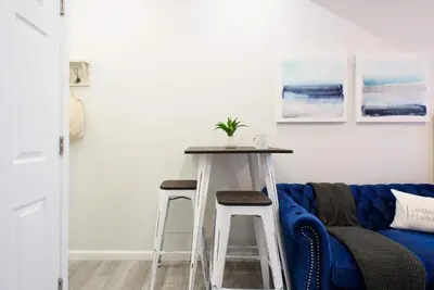 a living room with a table and a blue couch at 240-11 NEW STUDIO Prime Upper East W&D in New York