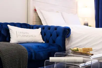 a blue couch sitting next to a bed at 240-11 NEW STUDIO Prime Upper East W&D in New York