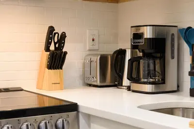a kitchen counter with two coffeemakers and a coffee maker at 240-12 BRAND NEW Studio Prime location W&D in New York