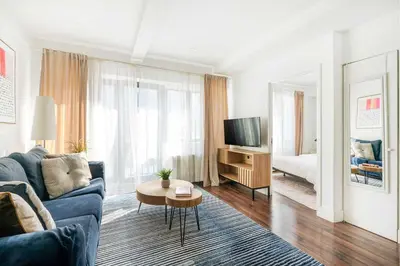 a living room with a blue couch and a tv at 809-4A Columbus Circle New BLDG 1BR W D in New York