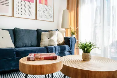 a living room with a blue couch and two tables at 809-4A Columbus Circle New BLDG 1BR W D in New York