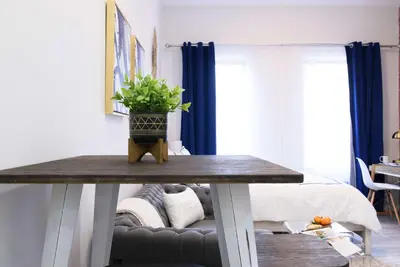 a table with a potted plant on it in a room at 240-14 NEW Studio Prime Location W&D in unit in New York