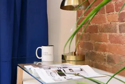 a glass table with a coffee mug on it at 240-14 NEW Studio Prime Location W&D in unit in New York