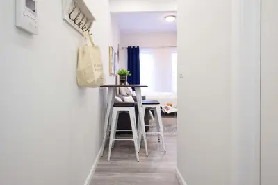 a hallway with a table and chairs in a room at 240-14 NEW Studio Prime Location W&D in unit in New York