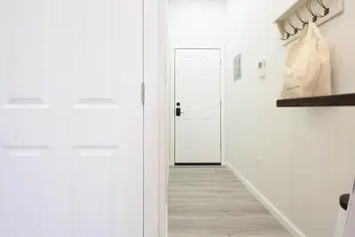a hallway with white walls and a white door at 240-14 NEW Studio Prime Location W&D in unit in New York