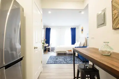 a room with a desk and a bed in a room at 240-15 Luxury Studio Prime Location W&D in New York