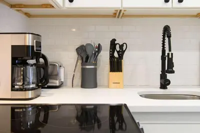 a kitchen counter with a coffee pot and utensils at 240-15 Luxury Studio Prime Location W&D in New York