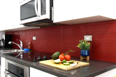 a kitchen counter with fruits and vegetables on a cutting board at 809-5A Gorgeous New 1BR Heart of Midtown in New York