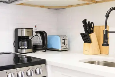 a kitchen counter with a toaster and a sink at 240-5 NEW Prime Location STUDIO W&D in unit in New York