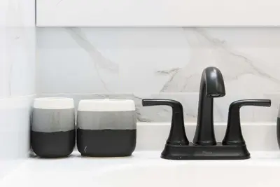 a kitchen counter with two cups and a faucet at 240-5 NEW Prime Location STUDIO W&D in unit in New York