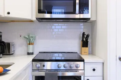 a kitchen with a stove and a microwave at 240-6 NEW STUDIO Prime Location W&D in unit in New York
